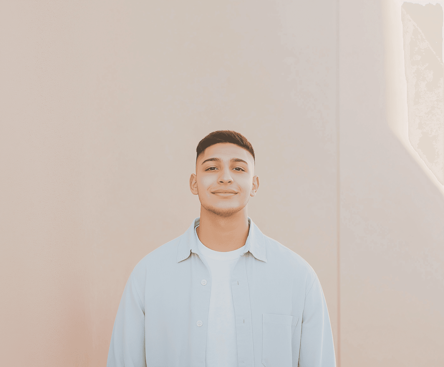 Portrait of Omar Haddad against a warm beige wall